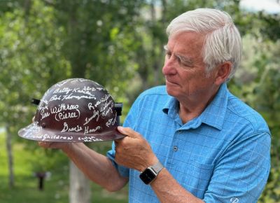 Bill Sniffin is pictured holding an old uranium miners helmet, signed for him by miners in appreciation for his work in exposing cancers that were occurring to them from the early uranium mining effort. He was nominated for a Pulitzer Prize for the series of stories.